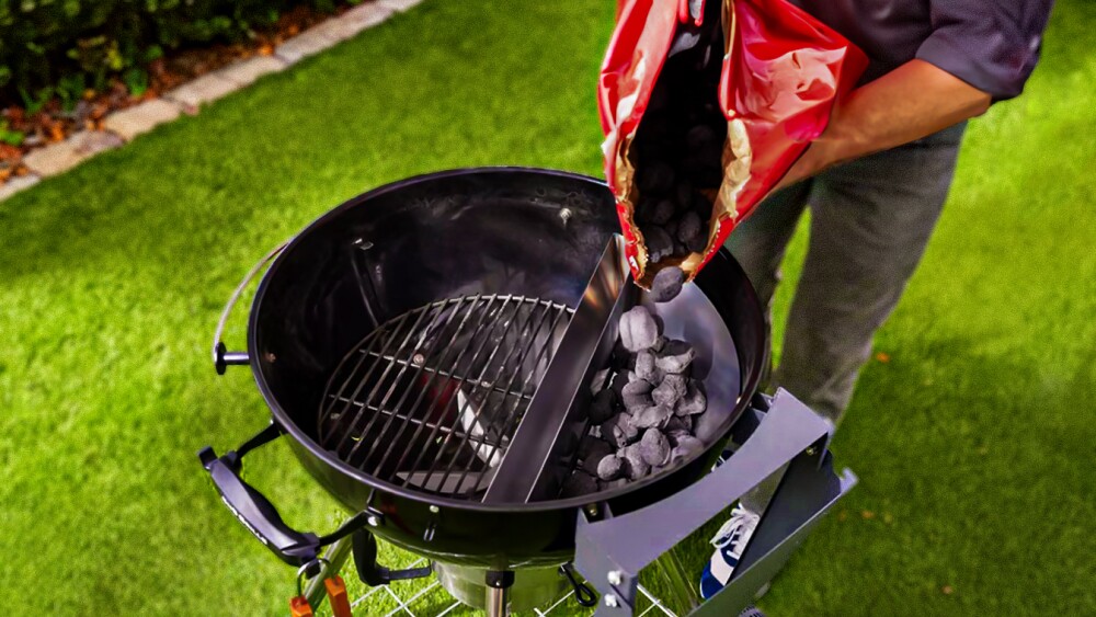 Closeup of an individual pouring charcoal into an SnS Grills insert