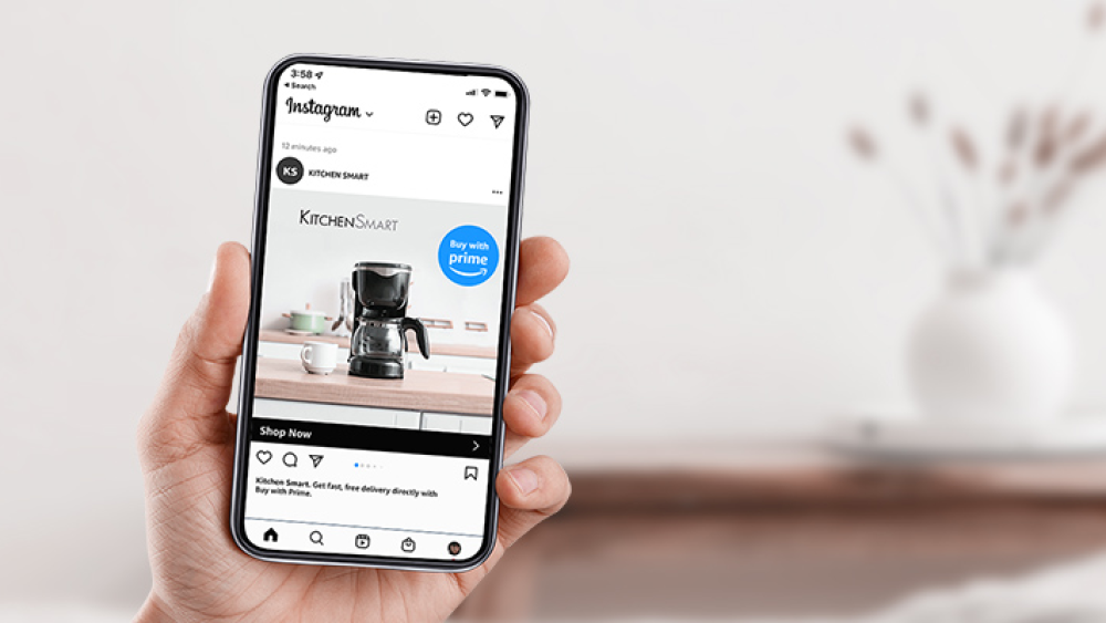 Hand holding phone with Buy with Prime on Instagram.