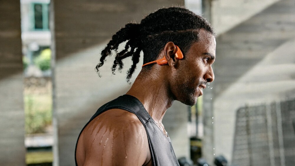 Athlete wearing Shokz open-ear headphones during a workout